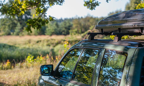 Vehicle with rooftop cargo ready for transport to campsite
